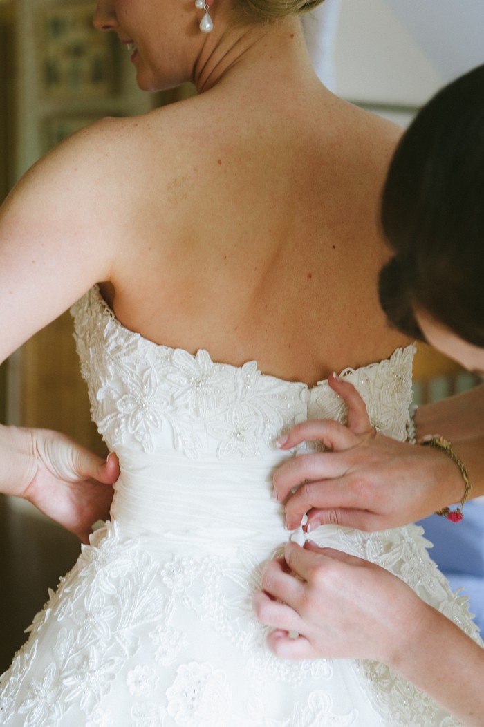 bride getting dressed zipped up wedding shopping